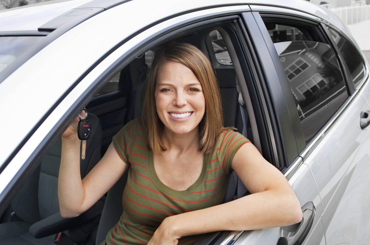female driver holding car keys