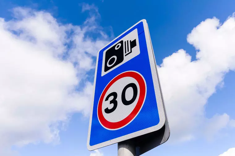 30mph speed limit sign with a speed camera warning